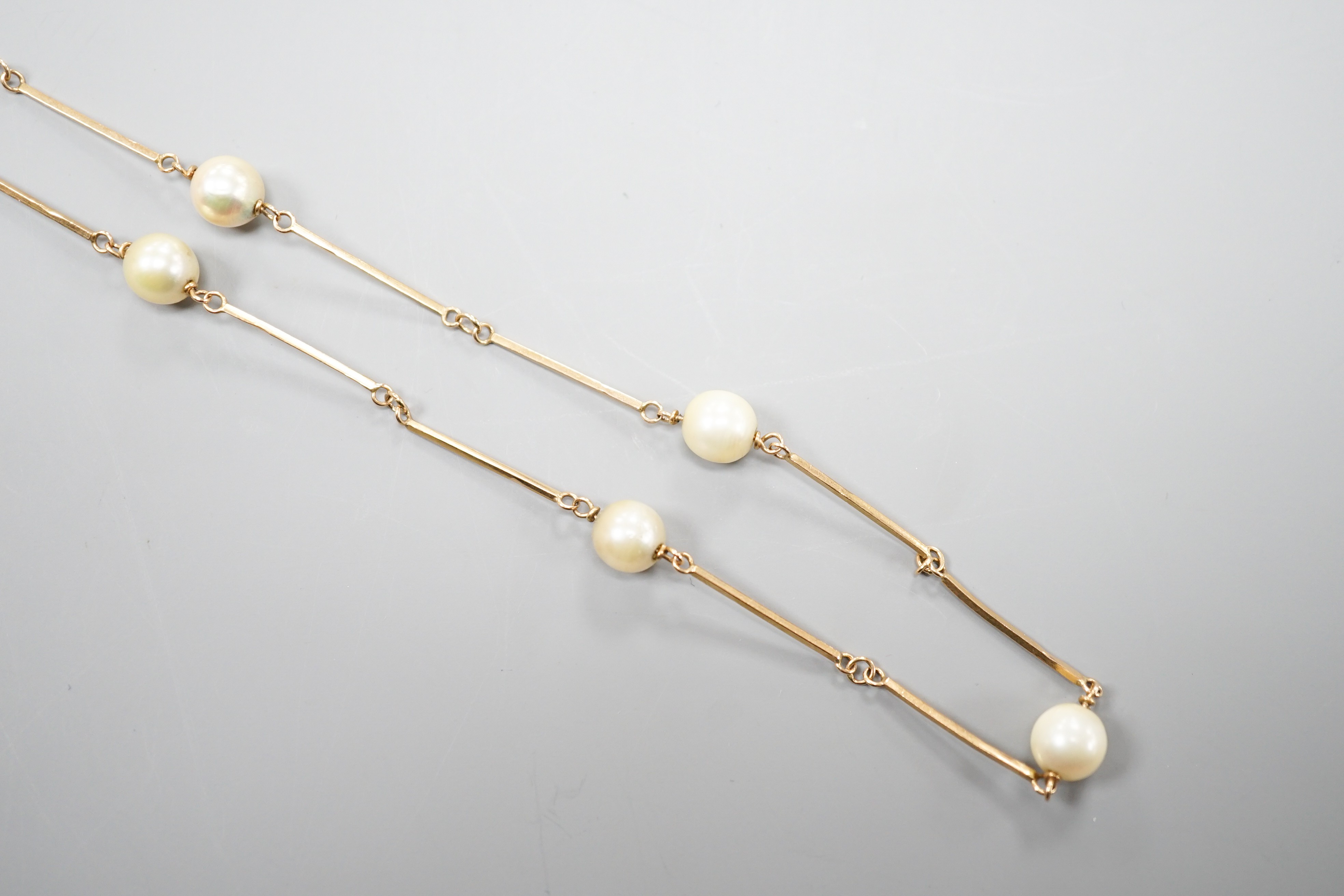 A yellow metal and cultured pearl set necklet, 70cm, gross weight 11.5 grams.
